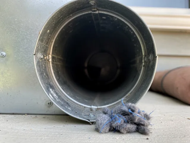 Azusa Dryer Vent Cleaning technician using specialized equipment to clear severe dryer vent blockage in Azusa